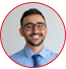 Smiling man in glasses with a beard and tie.